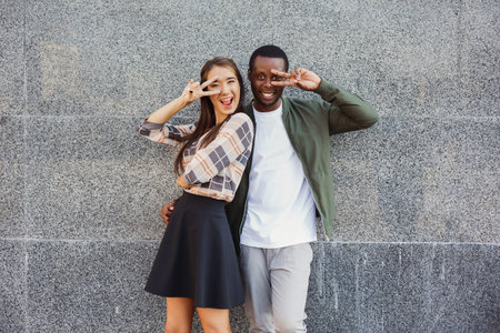 Collage of Two People Posing for a Fun Moment Outdoors Near a Stone Wall