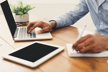 Collage of Work Activities at a Desk With Laptop, Tablet, and Notepad
