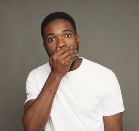 Man Covers Mouth in Surprise During Photo Shoot in Studio Setting for ICC Change Collection