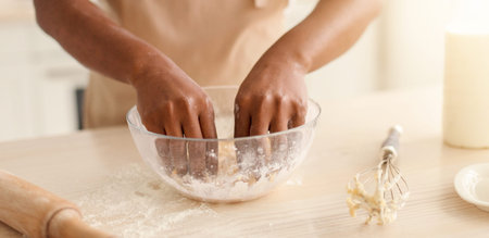 Person Mixes Dough in a Clear Bowl in Kitchen While Preparing for Baking Session