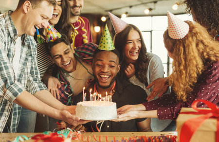 Group Celebrates a Birthday With Cake, Candles, and Festive Hats in a Lively Indoor Setting