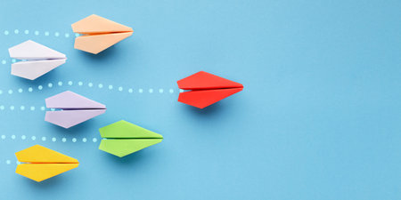 Red paper plane leading another ones, leadership concept