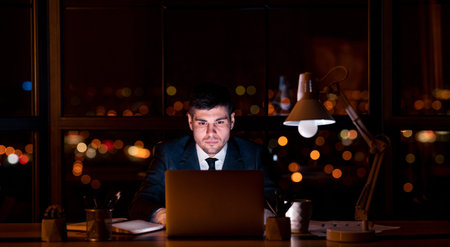 Businessman Working On Laptop At Night In Modern Office, Panorama