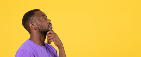 Thoughtful Black Male Considering Ideas With Hand On Chin, Profile View, Yellow Background