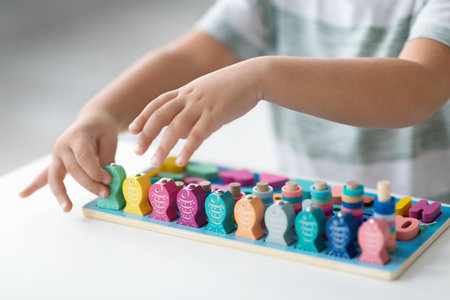 Child Playing With Colorful Educational Toy At Home, Engaging In Learning Activity