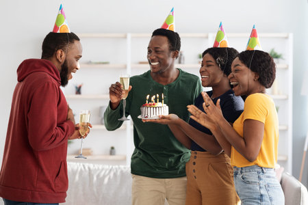 Happy black friends making surprise for birthday guy