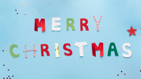 Colorful handmade letters on blue background with stars