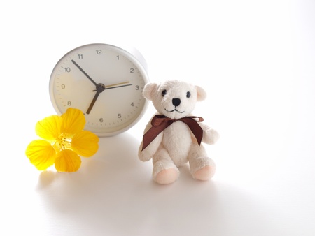 teddy bear, clock, and flowerの写真素材