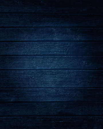 Dark blue wooden boards texture with a light effect with copy space for text.の写真素材