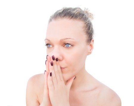 Blonde woman praying with her hands together.の写真素材