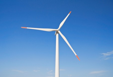 Wind turbine blade at blue sky.