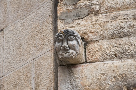 Stone face on brichwall.の写真素材