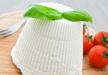 Ricotta cheese with basil leaves.
