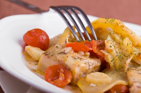 Fish, cherry tomatoes and potatoes.の写真素材