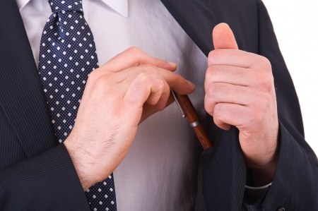 Businessman putting a pen in his pocket の写真素材