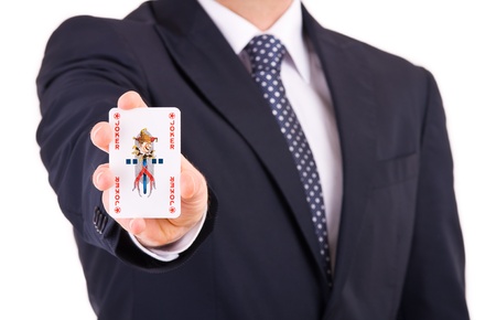 Businessman showing playing card 