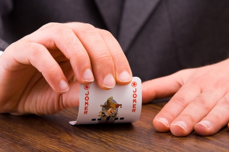 Businessman showing joker card のeditorial素材
