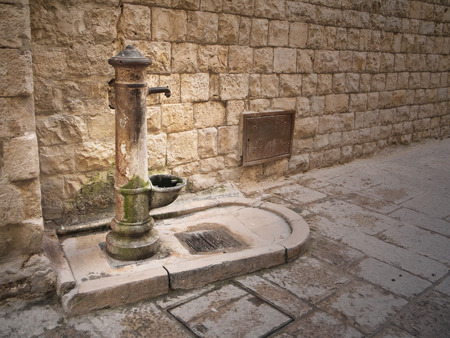 Rusty fountain in Oldtown of Molfetta. Apulia.