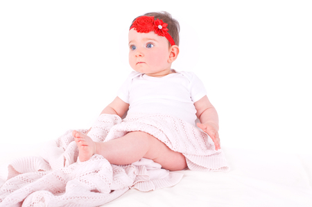 Baby girl with red ribbon.の写真素材