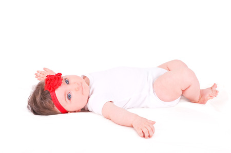 Baby girl with red ribbon.の写真素材