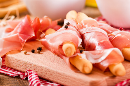 Grissini breadsticks with ham.の写真素材