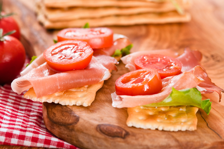 Crackers with ham and avocado.の写真素材