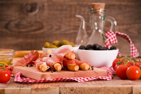 Grissini breadsticks with ham.の写真素材