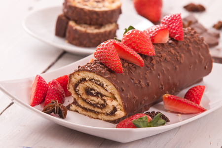 Chocolate roll with strawberries. の写真素材