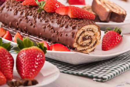 Chocolate roll with strawberries. の写真素材