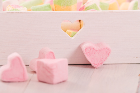 Marshmallows on wooden table. の写真素材
