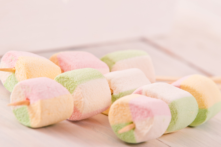 Marshmallows on wooden table. の写真素材
