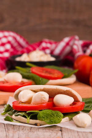 Tigella bread with spinach and tomatoes.の写真素材