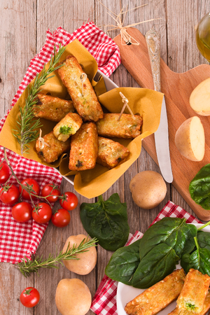 Potato croquettes with spinach and mozzarella.の写真素材