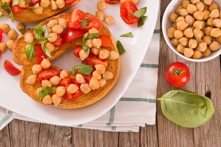 Friselle with tomatoes and chickpeas.の写真素材