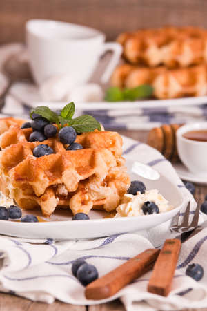 Waffles with blueberries and whipped cream.の写真素材