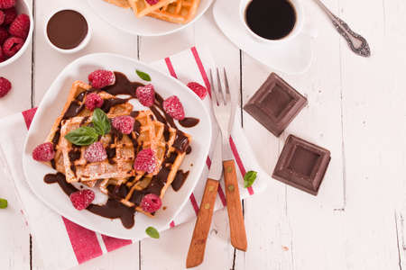 Waffles with raspberries and chocolate cream.の写真素材