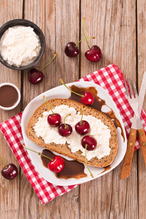Rye bread with cottage cheese and cherries.の写真素材
