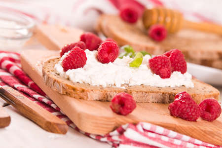 Rye bread with cottage cheese and raspberries.の写真素材