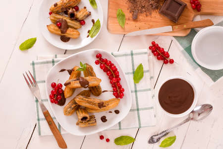 Mini churros with chocolate dipping sauce.