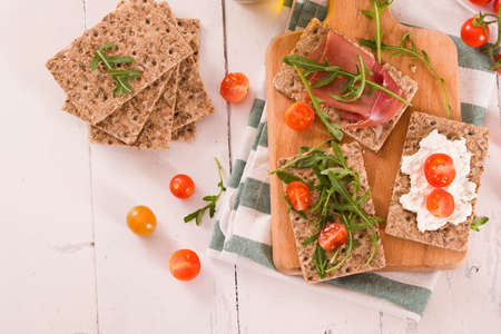 Crispy rye bread with sesame seeds, ham and cottage cheese.