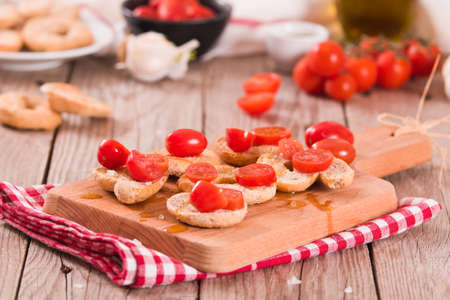 Friselle with cherry tomatoes and olive oil.