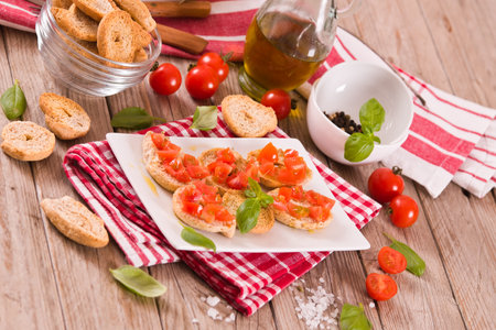Friselle with cherry tomatoes and basil.の写真素材