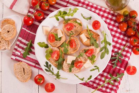 Friselle with cherry tomatoes and arugula.の写真素材