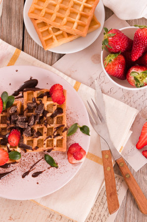 Waffles with strawberries and chocolate cream.の写真素材