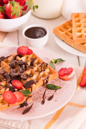 Waffles with strawberries and chocolate cream.の写真素材