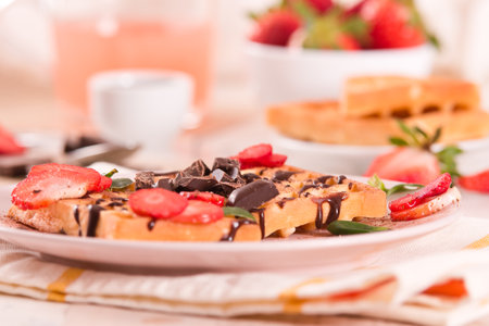 Waffles with strawberries and chocolate cream.の写真素材