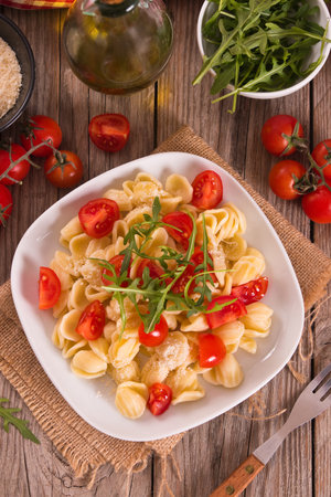 Orecchiette pasta with arugula and tomato.の写真素材