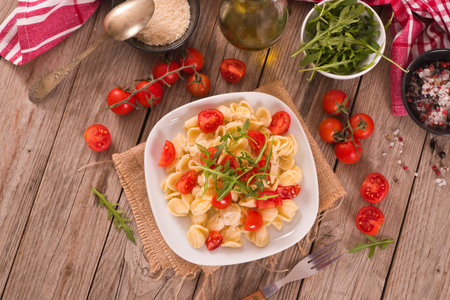Orecchiette pasta with arugula and tomato.の写真素材