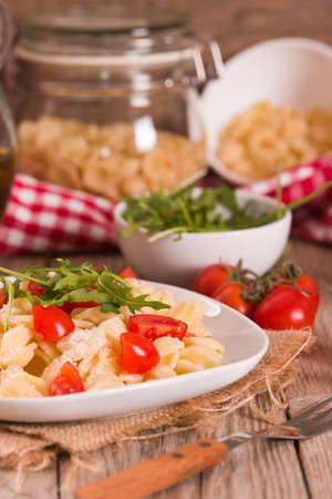 Orecchiette pasta with arugula and tomato.の写真素材