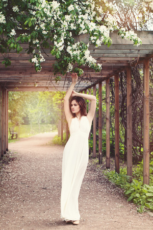 Glamorous Woman in Fashionable Dress Posing Outdoorsの写真素材